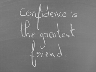 Confidence is the greatest friend handwritten on a chalkboard surface