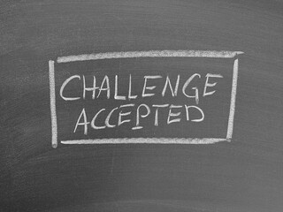 Challenge accepted text written with chalk on a blackboard surface