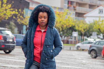 Woman in a coat crossing the street