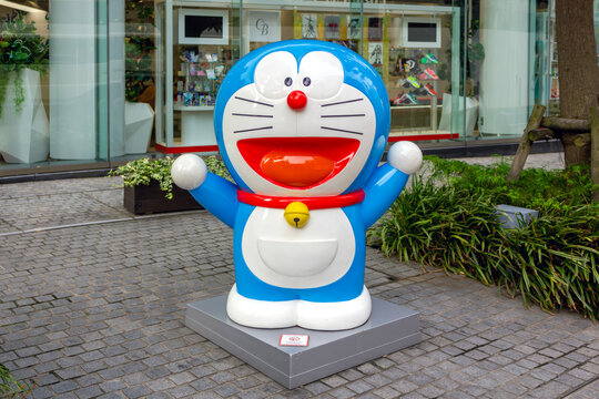 Tokyo, Japan - November 15, 2024: A cheerful statue of Doraemon, the beloved Japanese manga and anime character, standing outside a storefront in Tokyo, Japan. 