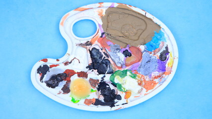 Artist's heavily used paint palette with colorful paint stains