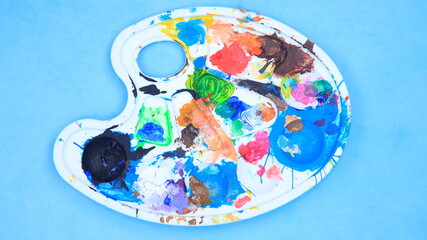 Artist's heavily used paint palette with colorful paint stains