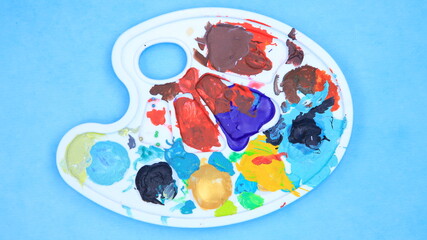 Artist's heavily used paint palette with colorful paint stains