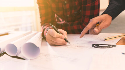 Teams of architects collaborate to review details for new construction projects and engineering...