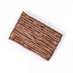 A rich brownie is presented with a smooth chocolate swirl on top, highlighting its appealing texture and indulgent flavor