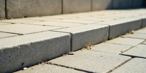 Fototapeta premium Close-up View of a Concrete Step and Pavers, Showing Texture and Detail