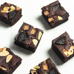 Indulgent brownies are arranged beautifully, showcasing layers of chocolate, crunchy cookies, and...