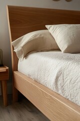 This modern bedroom features a sleek wooden frame bed, complemented by plush pillows for comfort. The room has a minimalist design with clean lines and simple furniture.