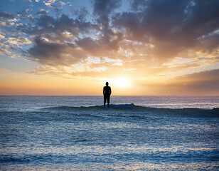 Fototapeta premium Solitary Silhouette Contemplating the Endless Ocean