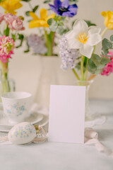 Mockup card on Elegant Breakfast Table Setting with Spring Flowers in Soft Tones
