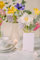 Mockup card on Elegant Breakfast Table Setting with Spring Flowers in Soft Tones