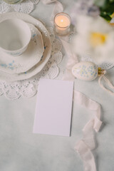 Mockup card on Elegant Breakfast Table Setting with Spring Flowers in Soft Tones