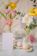 Mockup card on Elegant Breakfast Table Setting with Spring Flowers in Soft Tones
