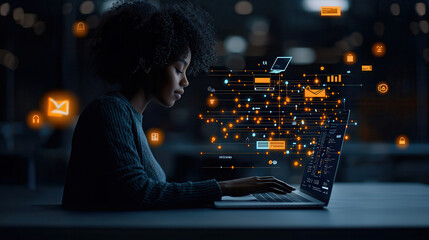 woman using laptop with digital data visualization in dark environment, showcasing technology and innovation