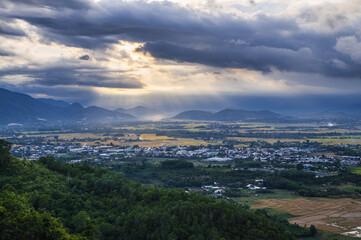 top view of rice fields with villages against background of mountains in Vietnam in Asia in the evening.