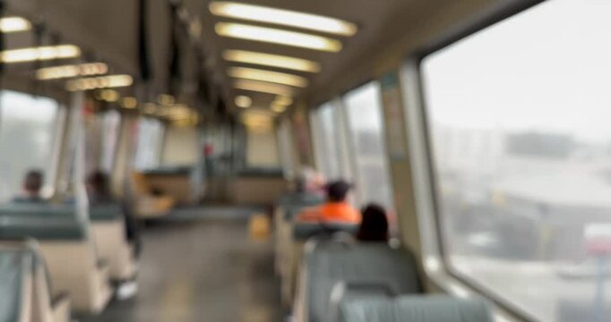 Defocused view of the interior of a train car belonging to a local public transit system.