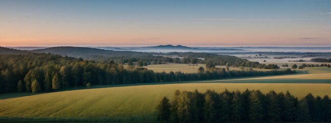 Obraz premium Misty sunrise over rolling hills