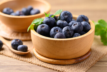 Blueberries in wooden bowl on wooden table, Healthy fruit, Food ingredient