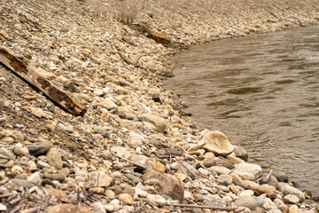 View of the stone bank of a mountain river in early spring
