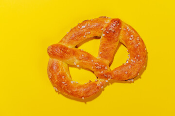 Pretzel scattered across a bright yellow background