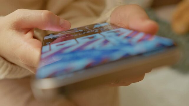 Female professional scrolling through social media content, navigating digital platform with focused thumb movements while sitting comfortably at home