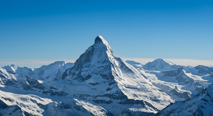 snow-capped mountain range under a clear blue sky