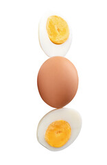 Top view of raw chicken egg and peeled cooked or boiled egg with egg yolk in two halves in stack isolated on white background with clipping path
