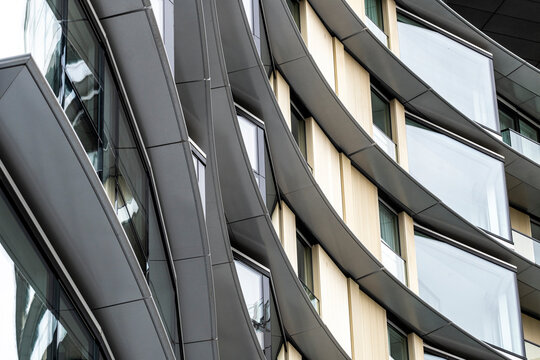 Apartment facade in London rise against the urban skyline, reflecting the city's dynamic mix of architecture. These residential buildings showcase modern living in a bustling metropolis, blending sty