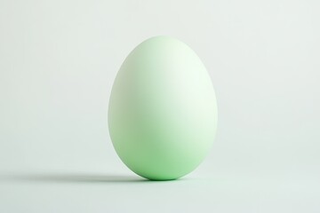 Fototapeta premium elegant pastel green easter egg centered on white backdrop showcasing its clean smooth finish under soft light