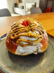 Italian style maritozzo with raspberry lying on a blue plate