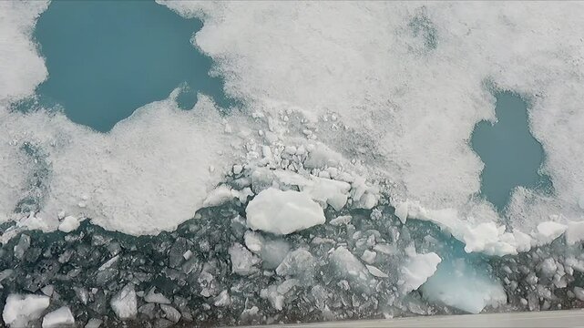 POV looking down from ship moving through arctic ice