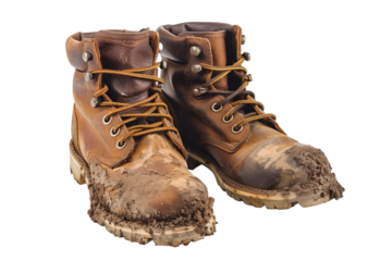 Pair of Muddy Leather Hiking Boots Isolated on a White Background Ready for Outdoor Adventures