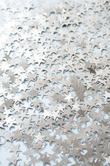 Stars shaped confetti as festive background.