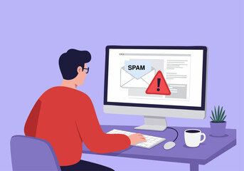 A person receives an email warning about spam on their computer screen, highlighting digital security concerns.