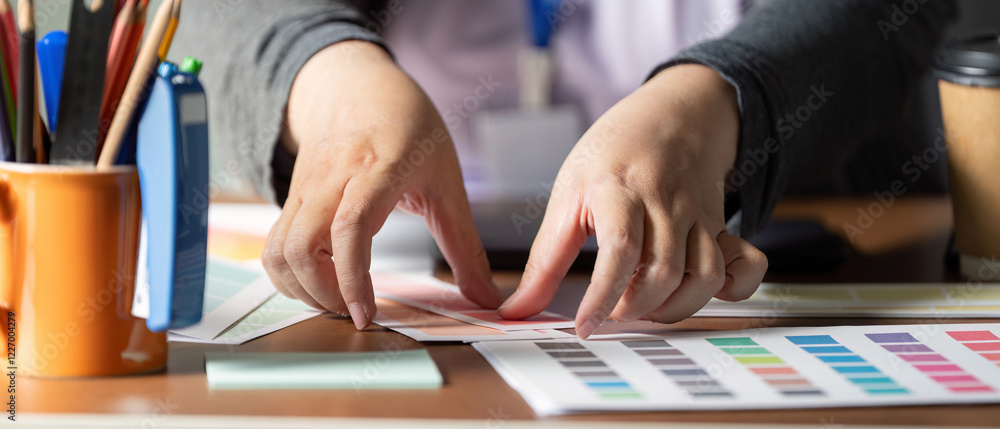 Poster hands arranging color palettes for graphic design and visual projects