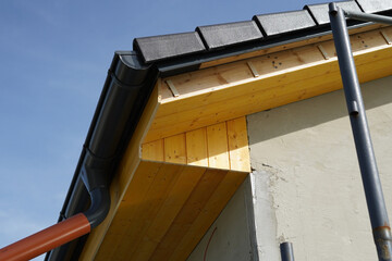 A piece of roof and wooden underlayment on a new building.