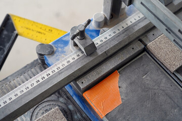 A ceramic tile cutter. We also see a lot of rulers for measuring straightness and length.