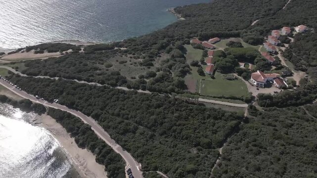 Drone footage of Rena di Levante and crystal-clear water on Capo Testa, Sardinia, Italy, in summer, showcasing white sand, turquoise sea, rolling dunes, and breathtaking Mediterranean scenery.
