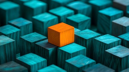 orange wooden block standing out among teal cubes