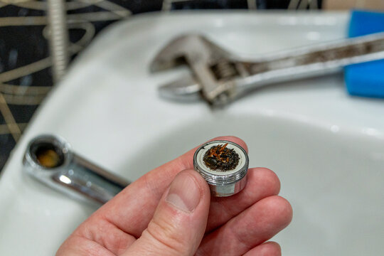 Dirt on the filter mesh of a disassembled mixer. Unclogging a bathroom faucet. Water quality
