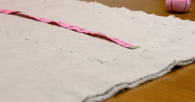 Measuring fabric and pinning it getting ready to sew.