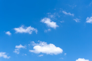Low angle view and full frame of beautiful blue sky with strange shape of fluffy white clouds in the morning or evening on sunny day used as natural background texture in decorative art work
