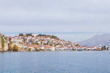 Obraz premium Picturesque view of Ohrid, North Macedonia, a historic town on Lake Ohrid shore, known for its charming architecture and stunning lake views, making it a popular tourist destination.