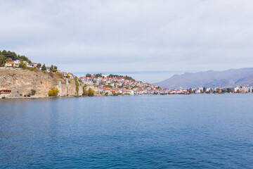Fototapeta premium Picturesque view of Ohrid, North Macedonia, a historic town on Lake Ohrid shore, known for its charming architecture and stunning lake views, making it a popular tourist destination.