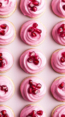 Fototapeta premium overhead view of the pink mini crackers, arranged like a pattern. Each cracker is topped with a goat cheese mousse, subtly dyed with beet juice, and pomegranate seeds. Placed on pastel colour surface