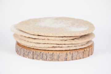 stack of flatbreads on a wooden board and on a white background