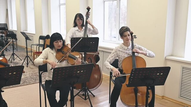 Modern musicians breathe fresh life into classical pieces. Strings explore experimental harmonies, showcasing evolution of musical artistryconcept Modern interpretations of classics 