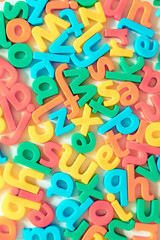 Colorful English alphabet letters background. Seamless types scattered randomly for learning languages concept, glossary, words, vocabulary, education, reading and writing in vintage childish style. 