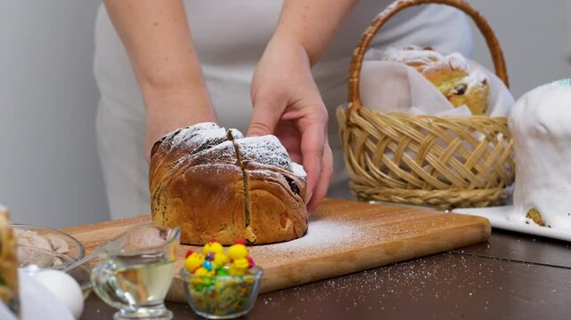Woman taking piece of traditional Easter cruffin cake Happy Easter concept