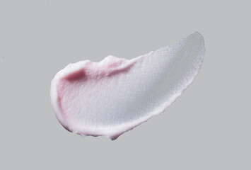 Cosmetic pink products creamy light pink texture smudge nude gray background